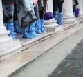 people with boots and special rain gaiters during the flood in V