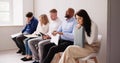 People Bored While Sitting On Chair Waiting For Job Interview