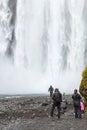 People in bottom of Skogafoss waterfall in Iceland Royalty Free Stock Photo