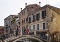 People on a bridge with old, typical, historical buildings