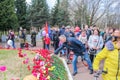 People bringing flowers to the graves of soldiers.