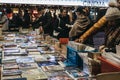 People browsing books at second hand book market in Southbank, London, UK, in the evening