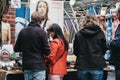 People browsing items at stalls inside Spitalfields Market, London, UK