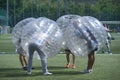 People in bubble inside putting heads together before a game