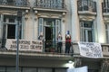 People in buildings with books in their hands as a symbol of protest in Argentina