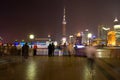 People at The Bund riverside looking at the skyline of Lujiazui and Pudong with the Oriental Pearl Tower, across the Huangpu river Royalty Free Stock Photo