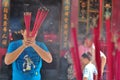 People with burner incense in hand pray at Jin De Yuan temple, Jakarta, Indonesia