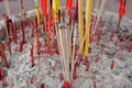 The people burning incense sticks in the Buddhist temple respect the Buddha image