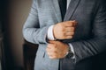 Close up of man dressing up and fastening buttons on shirt at home Royalty Free Stock Photo