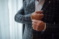 People, business, fashion and clothing concept - close up of man dressing up and fastening buttons on shirt at home Royalty Free Stock Photo