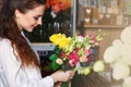 People, business, sale and floristry concept - happy smiling florist Royalty Free Stock Photo