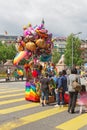 People buy balloons in the shape of a cartoon