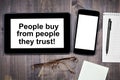 People buy from people they trust! Text on tablet device Royalty Free Stock Photo