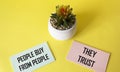 People buy from people they trust, it says on stickers and a yellow cactus background.