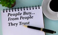 People Buy... From People they trust - words in a white notebook on a mint background with a cup of coffee Royalty Free Stock Photo