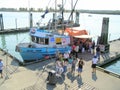 People buying fish from boat