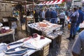 Local people and tourists buying fresh fish on a fish market