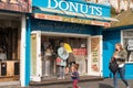 People buying freshly made donuts, from outdoor stall
