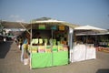 People buying honey at the outdoor market