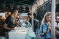 People buying ice-cream from Greedy Goat market stand in Borough Market, London, UK.