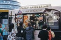 People buying ice-cream from Mr. Whippy van by Tower Bridge, London, UK
