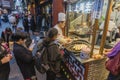 People buying pan fried Shanghai dumpling at a food stall