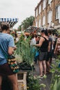 People buying plants and flowers at the Columbia Road Flower Market, London, UK. Royalty Free Stock Photo