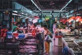 People buying and selling fish on seafood food market in HongKong