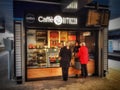 People buying snacks and refreshments from a cafe on the platform at Reading Railway Station.