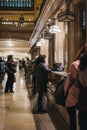 People buying tickets in a cashier window at Grand Central Terminal, New York, USA.