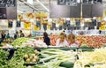 People buying vegetables at supermarket