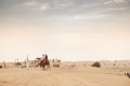 People camel riding in the desert Royalty Free Stock Photo