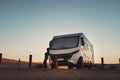 People and camper camping car van freedom concept lifestyle or alternative transport vacation. Big van parked off road and woman Royalty Free Stock Photo