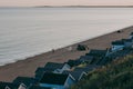 People camping and fishing on a beach by the huts in Milford on Sea, New Forest, UK