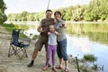 People camping and fishing, family active in nature, fish caught on bait, river and forest, summer season Royalty Free Stock Photo