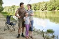 People camping and fishing, family active in nature, fish caught on bait, river and forest, summer season Royalty Free Stock Photo