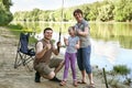 People camping and fishing, family active in nature, fish caught on bait, river and forest, summer season Royalty Free Stock Photo