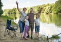 People camping and fishing, family active in nature, fish caught on bait, river and forest, summer season Royalty Free Stock Photo