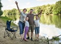 People camping and fishing, family active in nature, fish caught on bait, river and forest, summer season Royalty Free Stock Photo