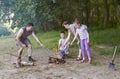 People camping in forest, family active in nature, kindle fire, summer season Royalty Free Stock Photo