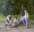 People camping in forest, family active in nature, kindle fire, summer season