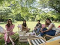 People on canvas chair in garden having afternoon tea and relaxing. Royalty Free Stock Photo