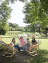 People on canvas chair in garden having afternoon tea and relaxing.