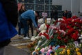 People carry flowers, candles, toys to a spontaneous memorial near the Crocus City Hall building