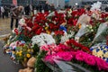 People carry flowers, candles, toys to a spontaneous memorial near the Crocus City Hall building