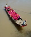 People carry flowers on river in Mekong Delta, Vietnam