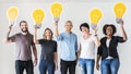 People carrying light bulb icons Royalty Free Stock Photo