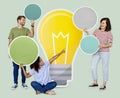 People carrying light bulb icons Royalty Free Stock Photo