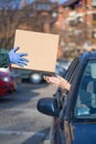 people in cars at distribution point giveaway receiving handouts