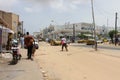 People and cars in a sandy street in city of Dakar in Senegal